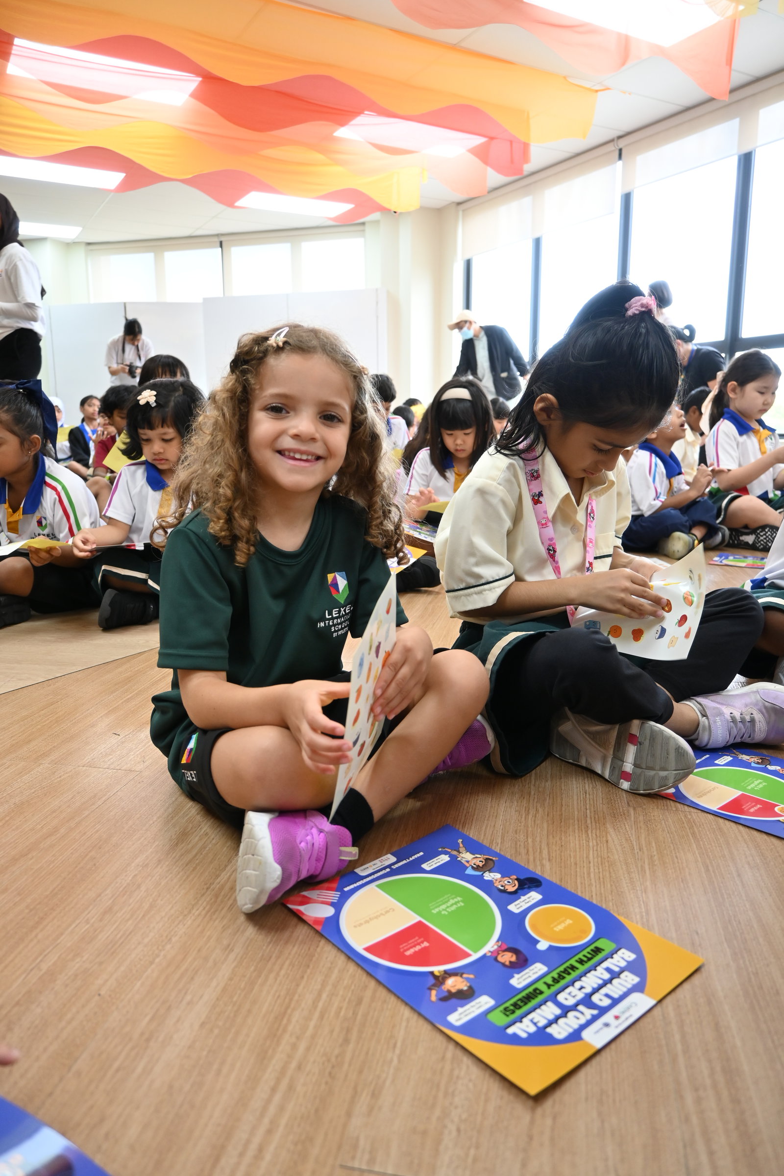 A Lexel Early Years student smiles while completing her Build Your Balanced Meal activity