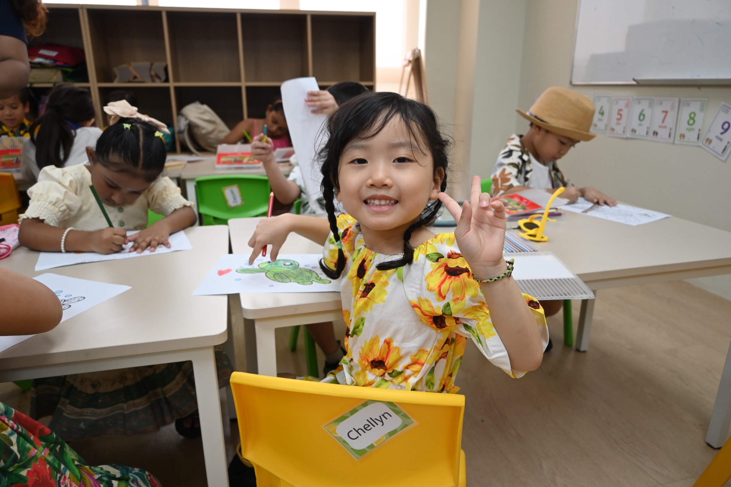 A Lexel Early Years student smiles during a classroom art lesson